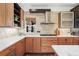 Well-lit kitchen featuring custom wooden cabinets, stainless steel appliances, and stone backsplash at 4577 Elm Ct, Denver, CO 80211