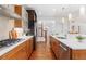 Modern kitchen with stainless steel appliances, ample cabinet space, and a view of the staircase at 4577 Elm Ct, Denver, CO 80211