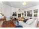 Cozy living room featuring a fireplace, hardwood floors, large windows, and comfortable seating at 4577 Elm Ct, Denver, CO 80211