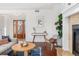 Inviting living room area featuring a cozy fireplace, stylish furniture, and a modern aesthetic at 4577 Elm Ct, Denver, CO 80211