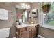 Well-lit bathroom featuring a large mirror, decorative wall art, and a sink at 503 15Th St, Golden, CO 80401