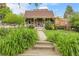 Charming front yard with lush greenery, flower beds, and a cozy porch with patriotic accents at 503 15Th St, Golden, CO 80401
