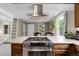 Open concept kitchen with stainless steel appliances, a range hood, and a large island at 503 15Th St, Golden, CO 80401