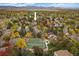 Aerial view of home, tennis courts, pool, and community at 8308 W 90Th Ave, Westminster, CO 80021