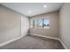 Bright bedroom featuring neutral walls, carpeting, and a large window at 8308 W 90Th Ave, Westminster, CO 80021