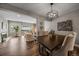 Elegant dining room with dark wood table and stylish light fixture at 8308 W 90Th Ave, Westminster, CO 80021