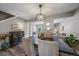 Bright dining room with dark wood table and view to living room at 8308 W 90Th Ave, Westminster, CO 80021