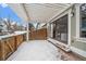 Covered patio with sliding glass door access to home, snow covered at 8308 W 90Th Ave, Westminster, CO 80021