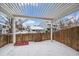 Covered patio with pergola and fenced backyard, snow covered at 8308 W 90Th Ave, Westminster, CO 80021