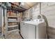 Utility area with washer, dryer, water heater, shelving, and exposed ceiling pipes and ductwork at 3150 N Fillmore St, Denver, CO 80205