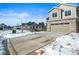 Townhome exterior featuring attached garage and winter landscaping at 5445 Canyon View Dr, Castle Rock, CO 80104