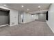 Finished basement with neutral carpet and access to a bathroom and other rooms at 12988 E 108Th Pl, Commerce City, CO 80022