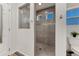 Modern shower room with tiled shower, glass door, decorative tile accents, and small window at 12988 E 108Th Pl, Commerce City, CO 80022
