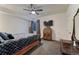 Cozy bedroom featuring a ceiling fan, wooden furniture, and a comfortable bed at 12988 E 108Th Pl, Commerce City, CO 80022