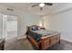 Comfortable bedroom with a wooden bed frame, soft pillows, and neutral carpeting at 12988 E 108Th Pl, Commerce City, CO 80022