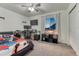 Bedroom featuring a large desk, mounted monitors, a ceiling fan, and modern decor at 12988 E 108Th Pl, Commerce City, CO 80022