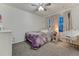 Cozy bedroom with whimsical decor, a ceiling fan, and a comfortable hanging chair at 12988 E 108Th Pl, Commerce City, CO 80022