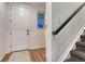 Bright entryway with hardwood floors, white door, window, and staircase with black handrail at 12988 E 108Th Pl, Commerce City, CO 80022