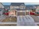 Charming two-story home with a three-car garage, covered porch, and well-maintained landscaping at 12988 E 108Th Pl, Commerce City, CO 80022