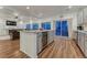 Bright and open kitchen featuring a center island with a wine fridge at 12988 E 108Th Pl, Commerce City, CO 80022