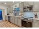 Updated kitchen with stainless steel appliances and neutral color palette at 12988 E 108Th Pl, Commerce City, CO 80022