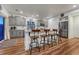 Modern kitchen with granite countertops, a large island, and stylish bar stools at 12988 E 108Th Pl, Commerce City, CO 80022