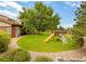 Expansive backyard with a vibrant lawn and a fun wooden playset, perfect for outdoor activities and Gathering enjoyment at 4180 S Yukon Way, Lakewood, CO 80235