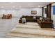 Basement living area with large sectional sofa, area rug, and adjacent dining area at 4180 S Yukon Way, Lakewood, CO 80235