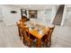 Basement dining area with wood table and chairs next to a living space with fireplace at 4180 S Yukon Way, Lakewood, CO 80235