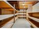 Unfinished basement storage area with shelves at 4180 S Yukon Way, Lakewood, CO 80235