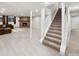 Finished basement with stone fireplace, staircase, and light vinyl plank flooring at 4180 S Yukon Way, Lakewood, CO 80235
