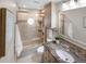 Bathroom featuring granite countertop, vanity, shower and bath combo at 4180 S Yukon Way, Lakewood, CO 80235