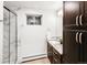 Updated bathroom with a tiled shower, granite countertops, and modern cabinetry at 4180 S Yukon Way, Lakewood, CO 80235