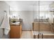 Bathroom featuring a modern glass shower and vanity with granite counters and neutral color palette at 4180 S Yukon Way, Lakewood, CO 80235