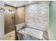 Beautifully remodeled bathroom with a soaking tub, walk-in shower, and stylish tile work at 4180 S Yukon Way, Lakewood, CO 80235
