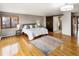 Bedroom with hardwood floors, neutral walls and an ensuite bathroom at 4180 S Yukon Way, Lakewood, CO 80235