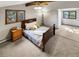 Bedroom featuring two windows, neutral carpet, a wooden bed frame, and an exposed beam on the ceiling at 4180 S Yukon Way, Lakewood, CO 80235