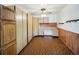 Versatile bonus room featuring ample storage cabinets, a built-in desk, and unique flooring, offering flexible space at 4180 S Yukon Way, Lakewood, CO 80235