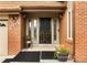 Inviting front porch with brick accents, a decorative storm door, and space for seating at 4180 S Yukon Way, Lakewood, CO 80235