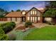 Attractive home with beautiful landscaping, a three-car garage and a brick facade at 4180 S Yukon Way, Lakewood, CO 80235