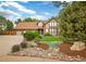 Charming home featuring manicured landscaping, a three-car garage, and a warm, inviting facade at 4180 S Yukon Way, Lakewood, CO 80235