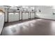 Spacious three-car garage with clean epoxy flooring and ample lighting, providing secure parking and extra storage at 4180 S Yukon Way, Lakewood, CO 80235