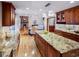 Open-concept kitchen flows into the living area, featuring granite countertops and stainless appliances at 4180 S Yukon Way, Lakewood, CO 80235