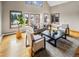 Bright and spacious living room featuring large windows, hardwood floors, and modern furniture at 4180 S Yukon Way, Lakewood, CO 80235