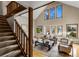 Open-concept living area with a staircase, large windows, and hardwood floors at 4180 S Yukon Way, Lakewood, CO 80235