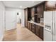 Convenient pantry area with custom cabinets, granite countertops, and wine rack at 4180 S Yukon Way, Lakewood, CO 80235