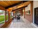 Bright sunroom with wooden paneled walls, tile floor, and views of the backyard at 4180 S Yukon Way, Lakewood, CO 80235