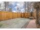 Back patio with a stamped concrete patio, tall privacy fence, and mature landscaping at 2514 N Humboldt St, Denver, CO 80205
