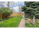 Back yard featuring a grassy area, landscaping and a paved walkway, ideal for gardening at 2514 N Humboldt St, Denver, CO 80205