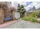 Back yard with mature landscaping, a shed, a patio area, and a blue bench under a trellis at 2514 N Humboldt St, Denver, CO 80205